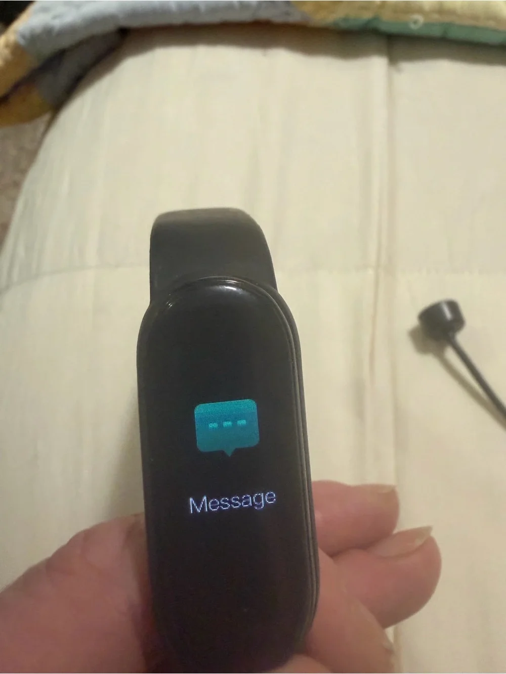 black Xiaomi Mi Band fitness tracker, model 6 or similar,